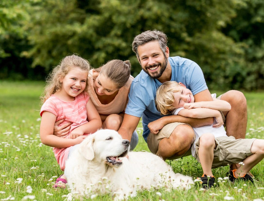 Happy family outside with their dog