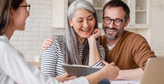 Older couple smiling, looking at estimate