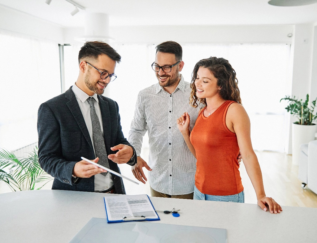 Realtor with clients signing the deal